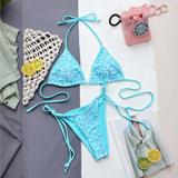 Beach Babes blue cheeky bottom triangle swimsuit with leopard print laid flat with summer accessories