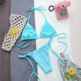 Beach Babes cheeky bottom triangle swimsuit in blue with leopard print and solid top laid flat with accessories