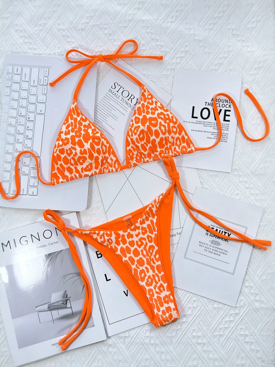 Beach Babes orange leopard print cheeky bottom triangle swimsuit with adjustable ties laid on white surface