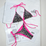 Beach Babes cheeky bottom triangle swimsuit with leopard print and pink trim laid out on white surface