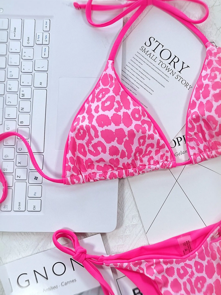 Beach Babes pink leopard print cheeky bottom triangle swimsuit with adjustable ties on marble surface