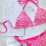 Beach Babes pink leopard print cheeky bottom triangle swimsuit with adjustable ties on marble surface