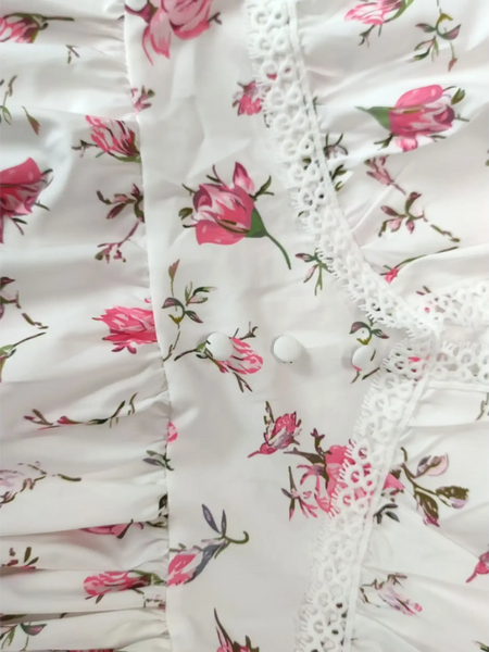 Close up of fabric mini dress with pink floral print and lace trim perfect chic beachwear dresses for curvy women