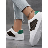 Trendsi chic beachwear sneakers with white base green accents and patterned sides worn with light denim jeans
