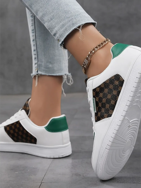 Trendsi chic beachwear sneakers with white base green accents and patterned sides worn with light denim jeans