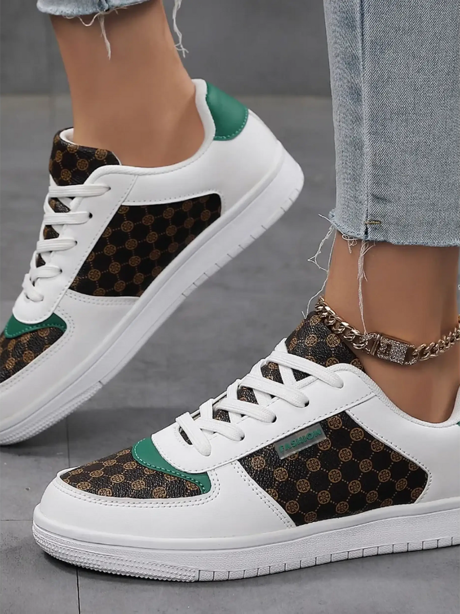 Trendsi chic beachwear sneakers white with brown patterned panels and green accents on model wearing jeans