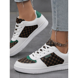 Trendsi chic beachwear sneakers white with brown patterned panels and green accents on model wearing jeans