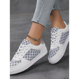 Trendsi chic beachwear sneakers in white with gray patterned panels worn with light wash jeans