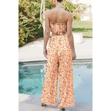 Trendsi floral chic boho beachwear set featuring a strapless top and wide leg pants by the pool