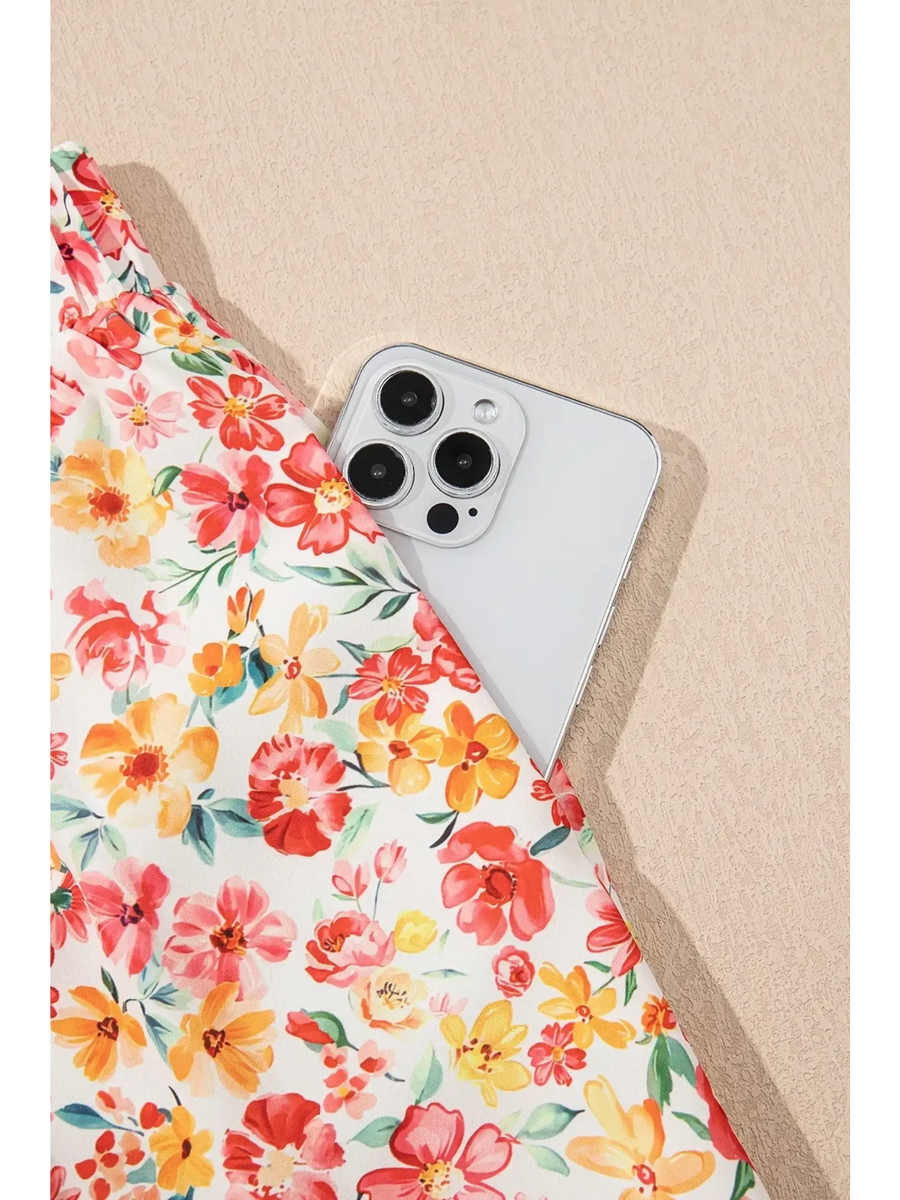 Trendsi floral pants set with colorful flowers featuring a pocket holding a white smartphone chic boho beachwear set