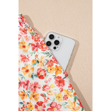 Trendsi floral pants set with colorful flowers featuring a pocket holding a white smartphone chic boho beachwear set