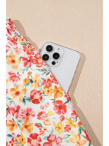 Trendsi floral pants set with colorful flowers featuring a pocket holding a white smartphone chic boho beachwear set