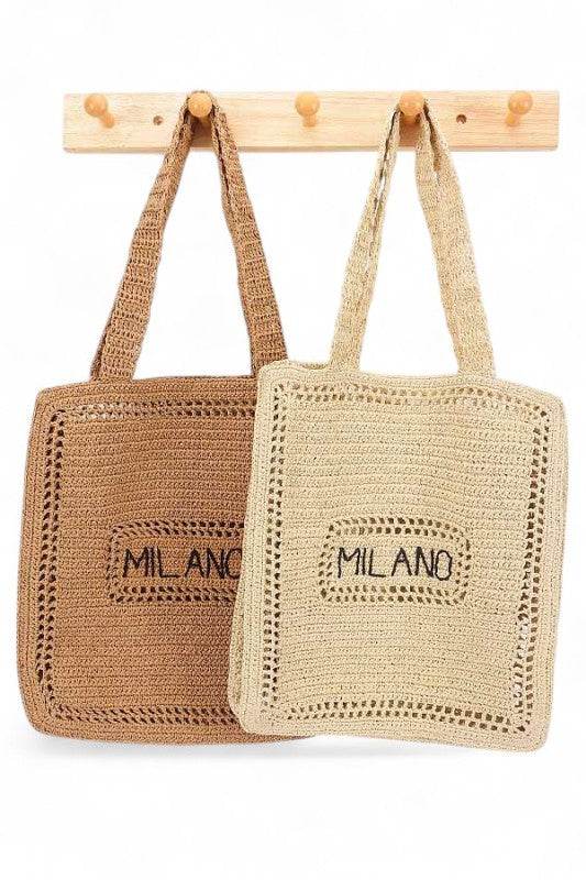 Chic Milano Straw Tote Bag – Your Essential Beach Wear in natural and brown colors hanging on wooden hooks