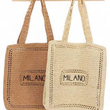 Chic Milano Straw Tote Bag – Your Essential Beach Wear in natural and brown colors hanging on wooden hooks