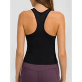Trendsi black chic racerback yoga tank for women shown from the back with purple leggings