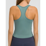 Back view of chic racerback yoga tank for women in sage green ribbed fabric by Trendsi