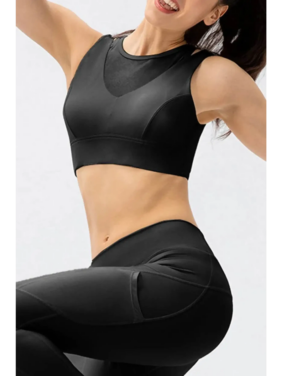 Babe Beachwear black chic summer exercise crop top active tank worn by smiling woman posing