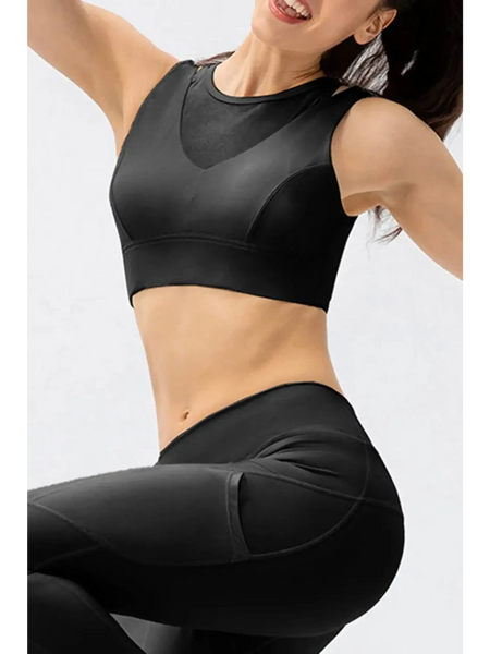 Babe Beachwear black chic summer exercise crop top active tank worn by smiling woman posing