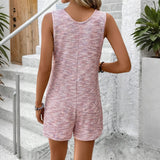 Woman wearing a pink sleeveless chic summer leisurewear romper by Babe Beachwear standing outdoors