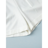 Close-up of white fabric hem detail of a Classy Long Sleeve Romper by Trendsi