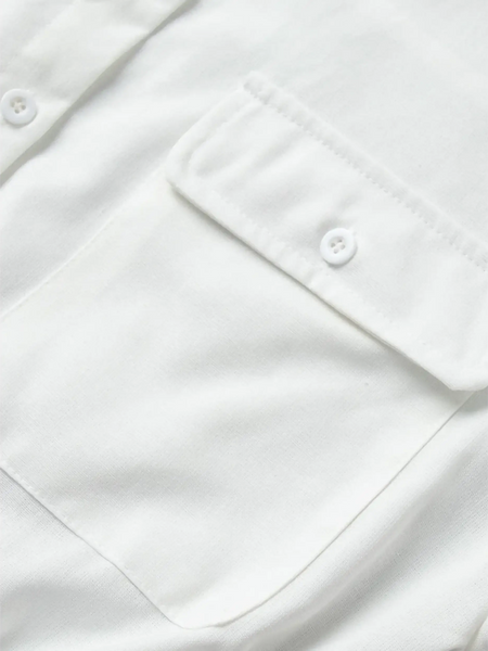 Close-up of white fabric pocket with button detail on a Classy Long Sleeve Romper by Trendsi