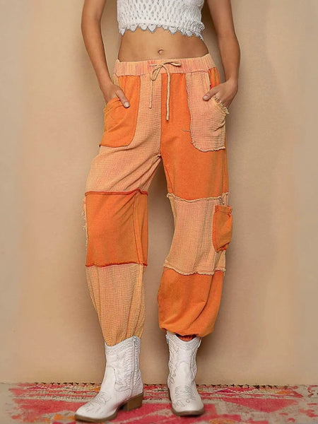 Orange patchwork pants with drawstring pocketed contrast for a trendy look