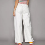 White cotton beach pants from Strut the Sand, perfect for fashion forward summer looks