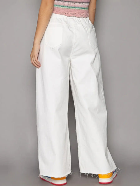 White cotton beach pants from Strut the Sand, perfect for fashion forward summer looks
