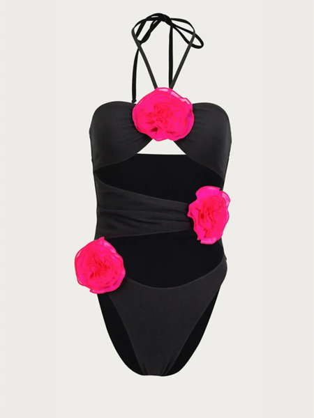Beach Babes color-block one piece bathing suit in black with bright pink floral accents and halter neck straps