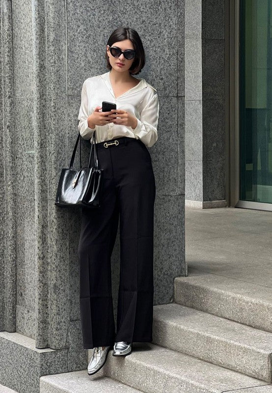 Woman wearing Babe Beachwear comfortable slip-on loafers for travel paired with black pants and white blouse