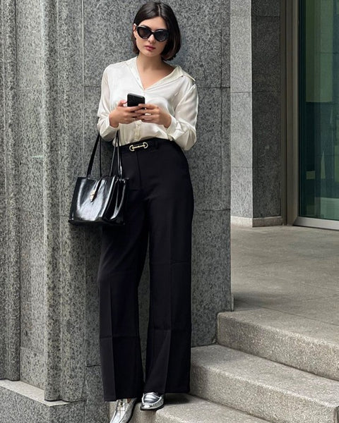 Woman wearing Babe Beachwear comfortable slip-on loafers for travel paired with black pants and white blouse