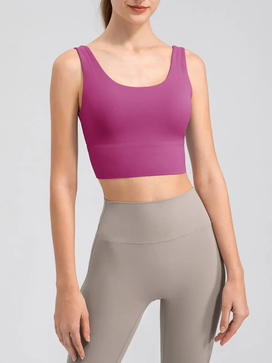 Babe Beachwaer comfortable summer exercise tank in purple worn by a woman with gray leggings