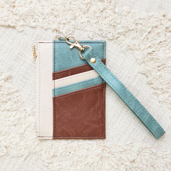 Babe Beachwear Compact Wrist Wallet and Card Case in brown blue and white with wrist strap on textured background