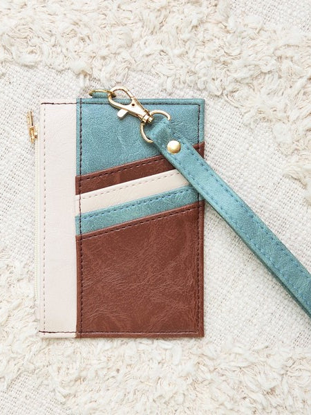 Babe Beachwear Compact Wrist Wallet and Card Case in brown blue and white with wrist strap on textured background