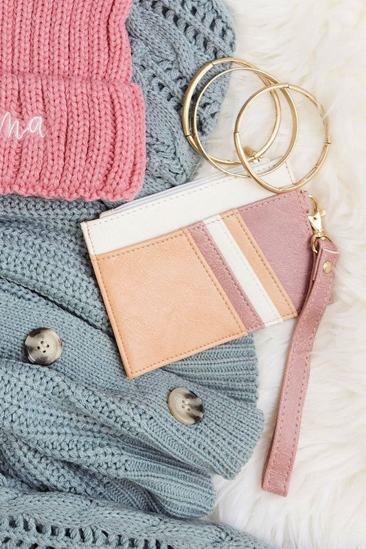 Babe Beachwear Compact Wrist Wallet and Card Case in soft pink and beige with gold key rings on knit sweaters
