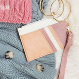 Babe Beachwear Compact Wrist Wallet and Card Case in soft pink and beige with gold key rings on knit sweaters