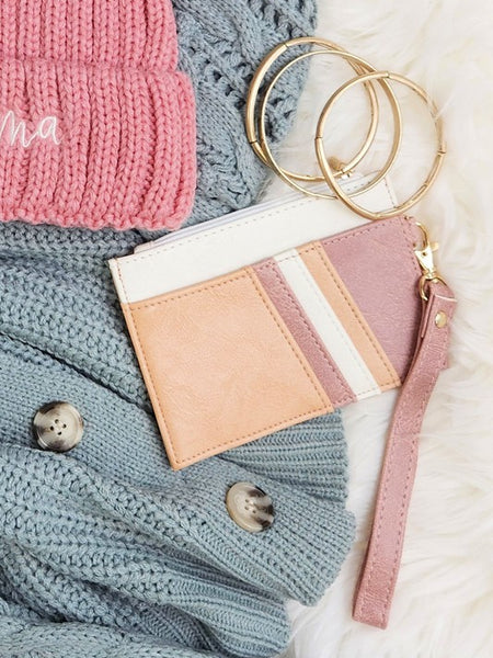 Babe Beachwear Compact Wrist Wallet and Card Case in soft pink and beige with gold key rings on knit sweaters