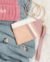 Babe Beachwear Compact Wrist Wallet and Card Case in soft pink and beige with gold key rings on knit sweaters