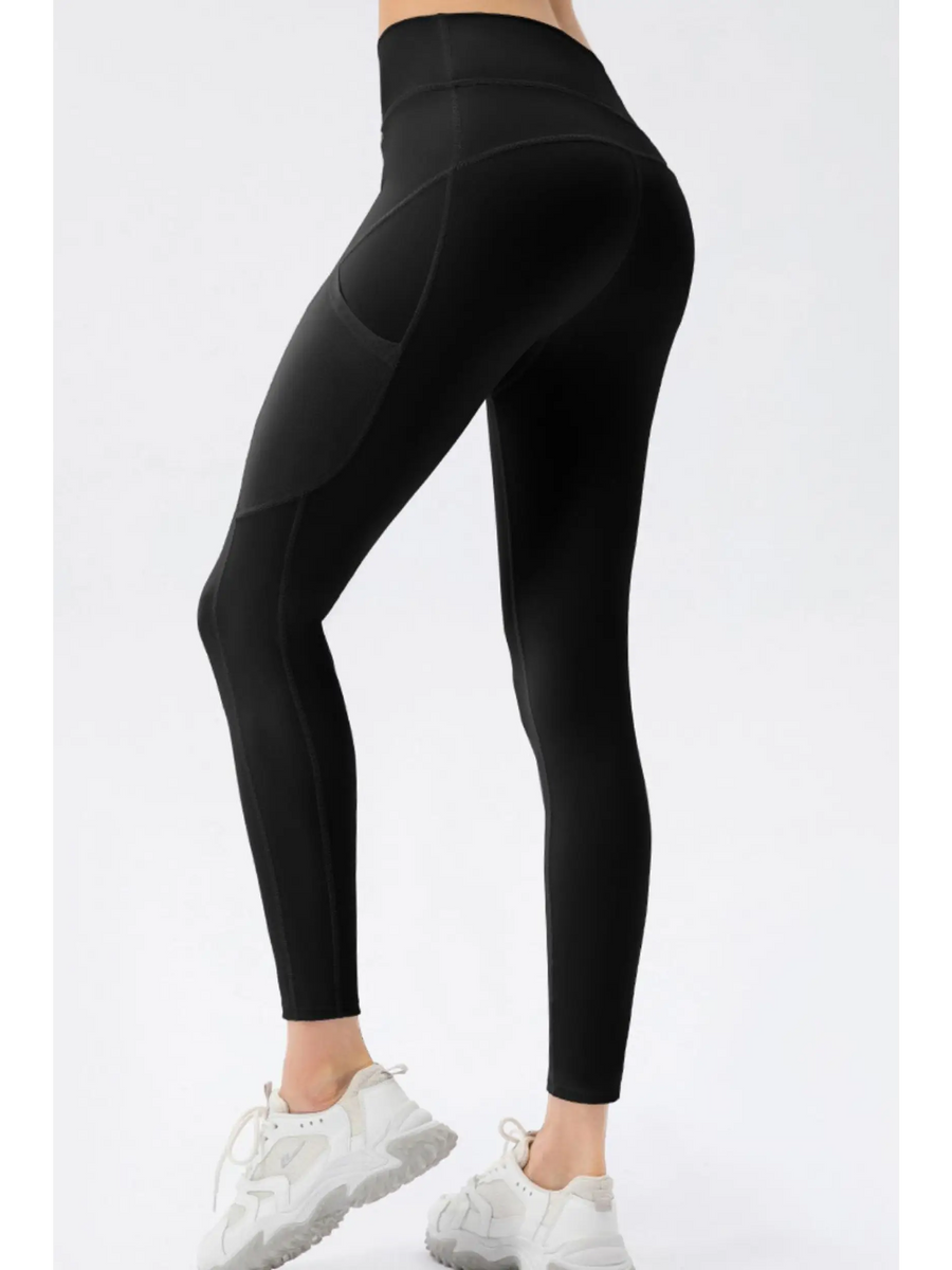 Trendsi black compression slim fit workout pants for women modeled with white sneakers