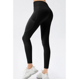 Trendsi black compression slim fit workout pants for women modeled with white sneakers