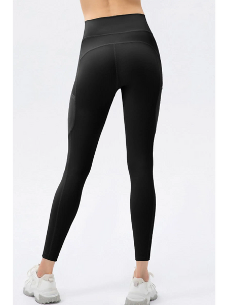 Trendsi black compression slim fit workout pants for women shown from the back with white sneakers