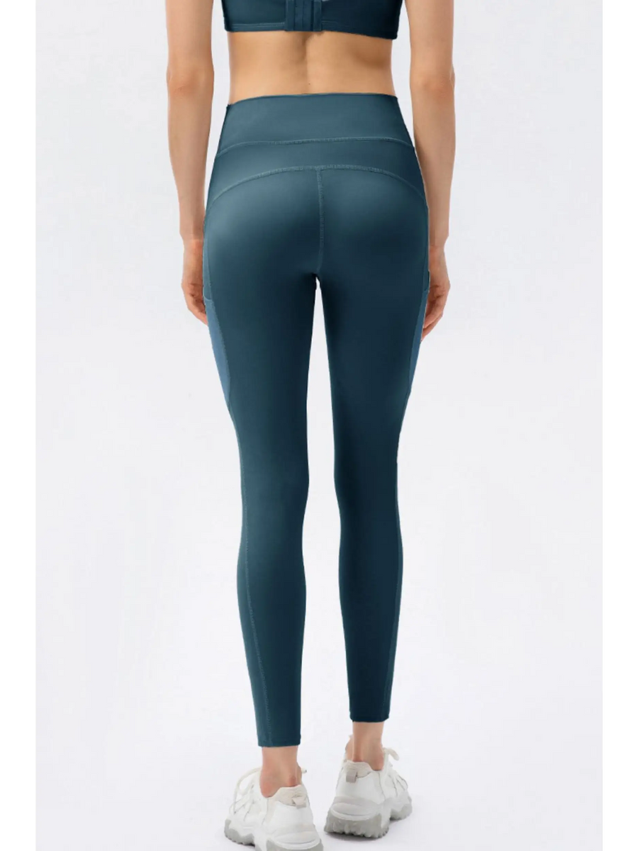 Trendsi compression slim fit workout pants for women in teal blue shown from back with white sneakers