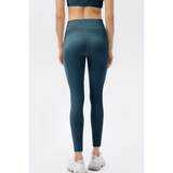 Trendsi compression slim fit workout pants for women in teal blue shown from back with white sneakers