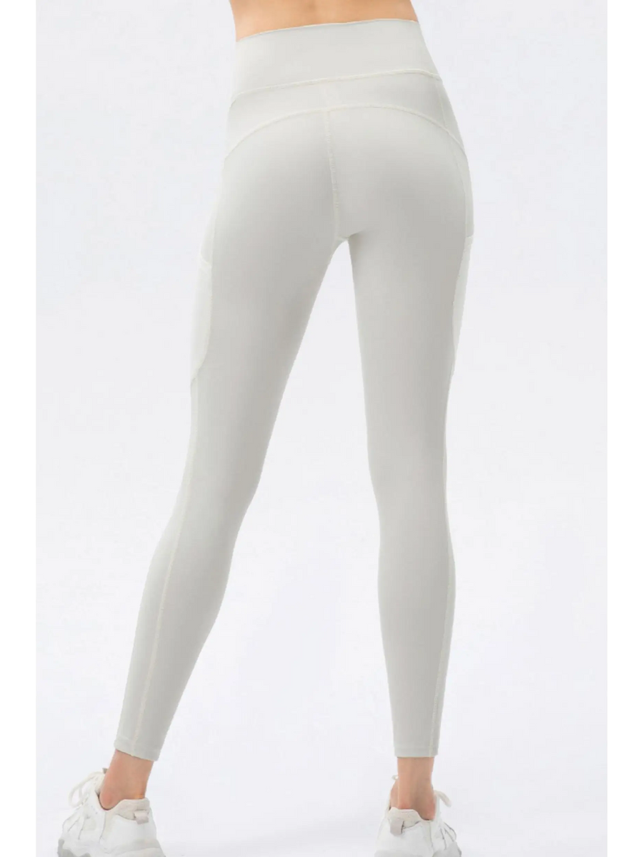 Trendsi white compression slim fit workout pants for women shown from the back with high waist design