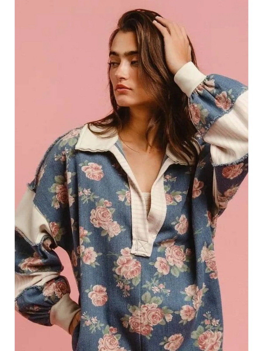 Woman wearing a Babe Beachwear contrast collar summer romper with floral print and long puff sleeves