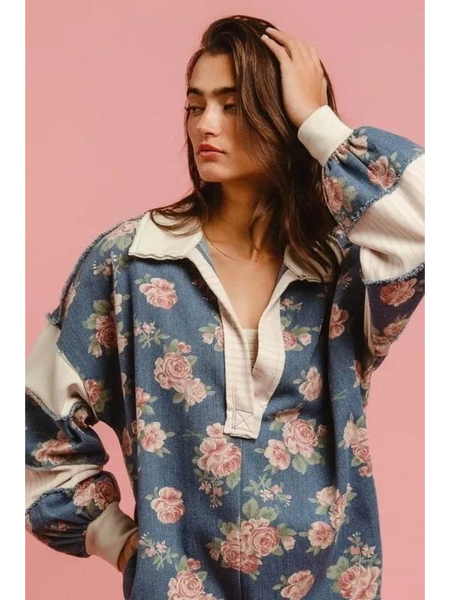 Woman wearing a Babe Beachwear contrast collar summer romper with floral print and long puff sleeves