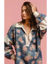 Woman wearing a Babe Beachwear contrast collar summer romper with floral print and long puff sleeves
