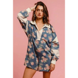 Babe Beachwear contrast collar summer romper with blue floral print and white trim on model