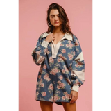 Woman wearing a Babe Beachwaer floral contrast collar summer romper with long sleeves and relaxed fit