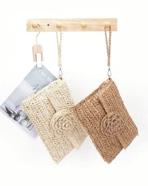 Babe Beachwear convertible straw purse for women in natural and tan colors hanging on wooden hooks